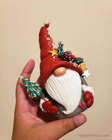 Christmas-themed Gonk made of cold porcelain clay being held Clay Gnomes Diy, Gnome Noel, Christmas Gonks, Clay Gnomes, Polymer Clay People, Božićni Ukrasi, Cold Porcelain Clay, Christmas Gonk, Polymer Clay Ornaments