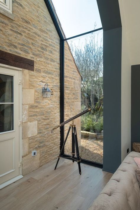 A glass up and over window created using structural glass by IQ. The frameless glass connects to the stone house using a channel design with glass to glass connections. Click the image to learn more about our glass link designs. Glass Corridor Extension, Glass Connection Between Buildings, Glass Link Between Buildings, Glass Roof Design, Glass Roof Extension, Farmhouse Extension, Bungalow Extensions, Cottage Extension, Swiss Cottage