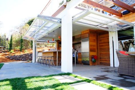 Glass Garage Doors for Patios | Beautiful patio that gets extended thanks to the glass garage doors Garage Door House, Bungalow Extensions, Indoor Outdoor Kitchen, Glass Garage Door, Garage Door Design, Enclosed Patio, Modern Garage, Roller Doors, Overhead Door