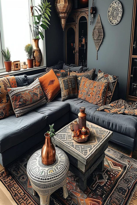 A boho-inspired living room with a dark gray couch and an array of patterned cushions and rugs, capturing a free-spirited vibe. Hippie Living Room Ideas, Hippie Living Room, Dark Grey Couch Living Room, Moroccan Decor Living Room, Bohemian Living Room Decor, Grey Couch Living Room, Moroccan Living Room, Bathroom Decor Ideas, Bohemian Living Room