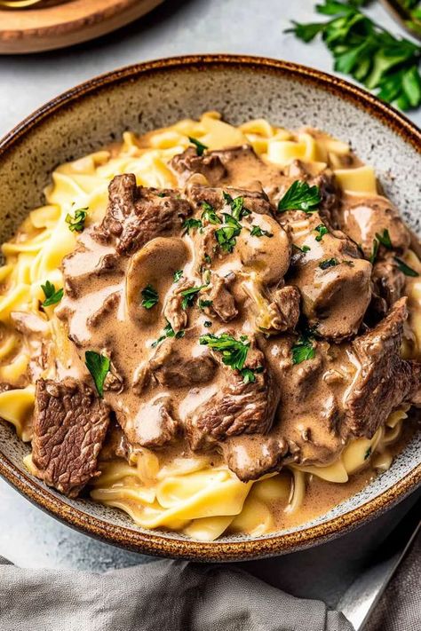 Indulge in a cozy classic with this creamy beef stroganoff recipe! Featuring tender beef, savory mushrooms, and egg noodles smothered in a rich sauce, this dish is both comforting and easy to make. Perfect for weeknight dinners or impressing guests, it takes just 30 minutes from start to finish. With variations like using ground beef or serving it over mashed potatoes, you’ll find your new favorite family meal here! 🍽️✨ #BeefStroganoff #ComfortFood #RecipeIdeas Braised Beef Stroganoff, Fancy Beef Stroganoff, 1950 Dinner Recipes, Cosy Dinner Recipes, Beef Meal Ideas, Creamy Beef Stroganoff Recipe, Creamy Beef Stroganoff, Classic Beef Stroganoff Recipe, Home Cooked Dinner