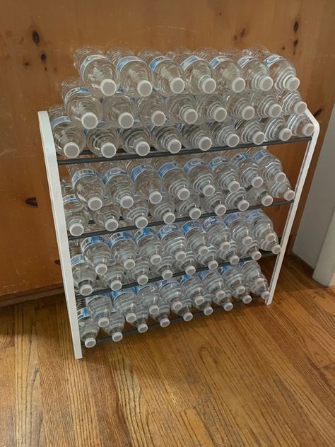 No more water cases sitting in the floor! $8 shoe rack from Walmart. Holds 2 cases of water! Shoe Rack For Water Bottles, Shoe Rack Drink Storage, Pantry Drink Organization, Water Storage Ideas Home, Bottled Water Storage Ideas, Pop Organization, Drink Organization, Diy Dollar Store Organization Ideas, Soda Storage