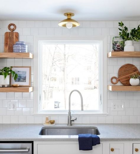 Gray Oak Studio on Instagram: "Design Tip: Keeping it clean with your kitchen sink open shelves. We love us some open shelves because they are an opportunity to bring color, texture and personality into a space. Especially in an all-white kitchen. But, they can also be an over-the-top, cluttered, hot mess express without some care and consideration. We recommend two objects per shelf. One with color, one with wood or a plant. It’s that easy.​​​​​​​​ ​​​​​​​​ Design: @grayoakstudio⁠​​​​​​​​ Proje Open Shelves Kitchen Window, Shelves Beside Kitchen Window, Open Shelving Beside Kitchen Window, Open Shelf Over Sink, Small Kitchen Window Over Sink Open Shelves, Lighting Over Kitchen Sink, Shelf Over Sink, Kitchen With Shelves, Kitchen With Open Shelves