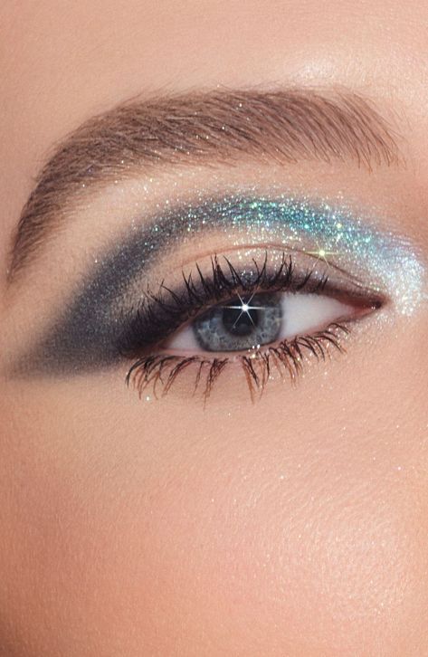 What it is: An all-in-one galaxy-inspired eyeshadow collection for instant on-the-go to ultraglam looks.What it does: Inspired by explosively sparkling, star-filled galaxies, this palette contains 12 pigmented eyeshadows ranging from neutral to turquoise tones in matte and intensely reflective metallic finishes. This essential collection features an easy-to-blend formula and a versatile color range for creating everything from subtle to dramatic summer eye looks.Shades include:- Galaxy (matte deep blue with bluish-green sparkle)- Space Dust (matte sandstone)- Comet (matte toasted peach)- Eclipse (matte muted plum)- Supernova (duo-chrome pink lilac with multidimensional sparkle )- Mars (matte rusty brown)- Dark Matter (matte black violet)How to use: Apply light eyeshadow shades to accentuat Shimmering Eyeshadow, Sparkly Glam Makeup, Sparkle Eyeshadow Looks, Eye Makeup With Stars, Midnights Era Makeup, Silver Eye Shadow, Turquoise Makeup Looks For Brown Eyes, Blue Eyeshadow Hooded Eyes, Blue Eyes Makeup Looks