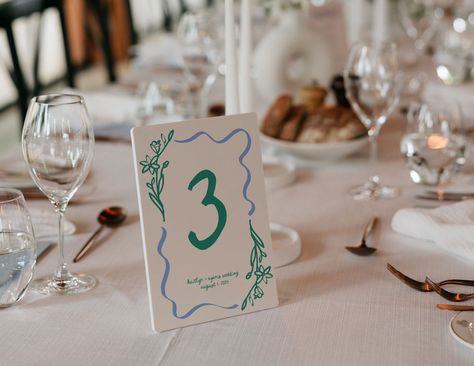 🤍SALES🤍 Buy THREE items and save 15% with code SAVE15 Buy FOUR items and save 35% with code SAVE35 Make your wedding reception pop with our hand-drawn table numbers template! These colorful and whimsical wavy table numbers are perfect for adding a unique touch to your special day. With handwritten illustrations, these modern table numbers are not only a practical way to help guests find their seats but also double as beautiful wedding decor. Our printable wedding table numbers are available fo Colorful Wedding Table, Watercolor Table Numbers, Floral Table Numbers, Handwritten Wedding, Numbers Template, Wedding Table Numbers Printable, Table Assignments, Number Templates, Signing Table Wedding