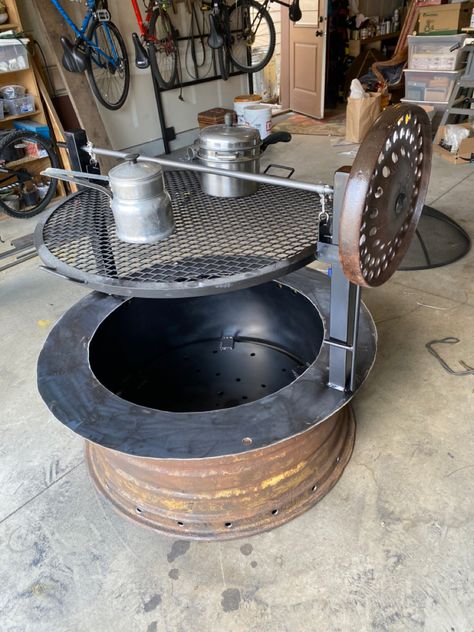 Tractor rim fire pit Rim Fire Pit Ideas, Tire Rim Fire Pit, Backyard Oven, Cowboy Fire Pit Grill, Custom Metal Fire Pit Rings, Tractor Rim Fire Pit Ideas, Rim Fire Pit, Tractor Tire Rim Fire Pit, Oven Ideas