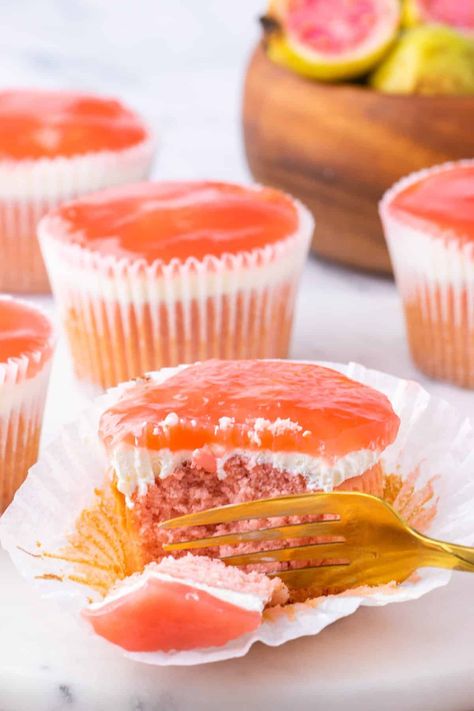 Gold fork taking a piece of the cupcake and showing the layers of cream cheese. Guava Desserts Easy, Guava Cake Recipe From Scratch, Guava Cake Recipe, Guava Cookies, Hawaii Cupcakes, Guava Cupcakes, Hawaii Desserts, Guava Desserts, Hawaiian Dessert