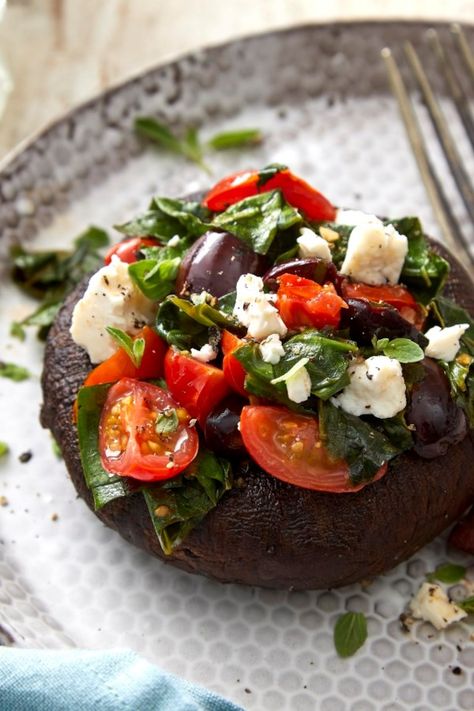 A mixture of tomatoes, spinach, feta, olives and fresh oregano gives portobellos a Mediterranean vibe in this healthy stuffed mushroom recipe. Serve these along with chicken, fish or tofu as a super-satisfying side dish, or add a hearty salad and make them the centerpiece of a vegetarian dinner. #dinner #supper #dinnerideas #supperideas #dinnerrecipes #supperrecipes #healthydinnerideas #healthysupperideas #healthydinnerrecipes #healthysupperrecipes #recipe #eatingwell #healthy Healthy Stuffed Mushrooms, Portobello Mushroom Recipes, Portabella Mushrooms, Mushroom Recipes Healthy, Stuffed Portobello, Stuffed Mushroom, Hearty Salads, Cheese Salad, Portobello Mushroom