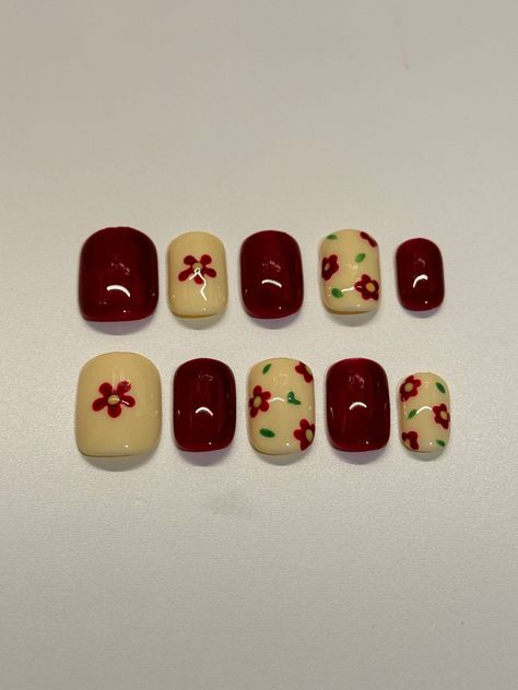 Colour base: Red and Cream Elements: Hand painted Style: Short square Set of nails include: * Set of 10 Press On Nails Hand painted with gel polish * Nail glue * Nail tabs * Mini nail file * Mini cuticle pusher * Alcohol swab Color Variations: Colors may vary from the actual product depending on the viewing screen. We strive to accurately represent our products, but slight differences in color may occur. Handmade Variations: Each set of nails is 100% handmade, leading to slight variations in des Square Red Nails Design, Short Nail Flower, Cute Nail Art For Short Nails, Funky Nails Short, Flower On Nails, Square Nails Red, Simple Red Nails, Gel Short Nails, Cute Red Nails