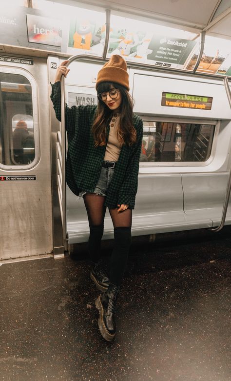 tan shirt, dark shorts, black tights, black thigh high socks, black combat boots dark green plaid button down shirt, tan beanie Green Dress With Tights, Combat Boots Outfit Fall, Outfits With Black Tights, Green Flannel Outfit, Thigh High Socks Black, Shorts And Tights Outfit, Green Thigh High Boots, Thigh High Combat Boots, Jag Lever