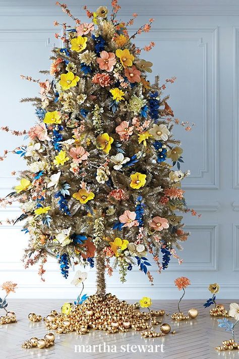 This fancy gold-tinsel tree is in full bloom for the season. The fabric flowers all started white—we chose hydrangeas, lilies, anemones, and cherry blossoms, then spray-painted them in a vibrant palette and gave them gold ballpick centers. For more glimmer, add gold bulbs. #christmas #holidayideas #christmasideas #wintertodo #marthastewart Christmas Tree Spray, Floral Christmas Tree, Christmas Tree Decorating Ideas, Christmas Tree Inspo, Christmas Tree Decor Ideas, Tree Decor Ideas, Tree Decorating Ideas, Tinsel Christmas Tree, Christmas Tree Decorating