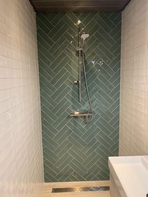 Dark Green Herringbone Tiles, Green Chevron Tile Bathroom, Green Herringbone Shower Tile, Dark Green Herringbone Tiles Bathroom, Bathroom With Herringbone Tile, Sage Herringbone Tile Bathroom, Herring Bone Tiles Bathroom, Herringbone Shower Accent Wall, Green Tiles Toilet