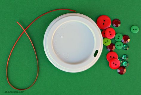 Upcycle your coffee cup lid into a festive Christmas ornament Plastic Coffee Lids Crafts Ideas, Plastic Coffee Cup Lids Crafts Ideas, Crafts With Coffee Cup Lids, Coffee Cup Lid Crafts, Coffee Lid Crafts, Morning Centers, Lid Crafts, Plastic Coffee Cups, Holiday Kids