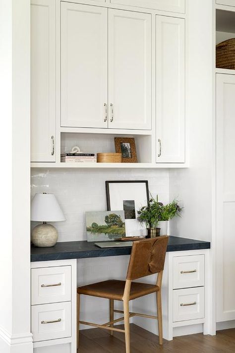 Kitchen features a buttoned leather chair at a built in desk with white drawers and honed black marble countertop and white cabinets on white subway tiles. Studio Mcgee Home Office, Kitchen Office Nook, Marble Top Desk, Studio Mcgee Home, Mcgee Home, Kitchen Desks, Message Center, Kitchen Desk, Floating Cabinets