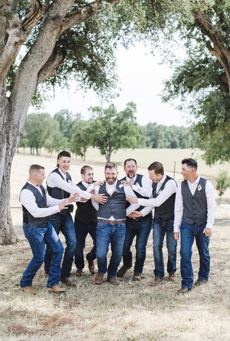 Groomsmen in grey vests and blue jeans point to the groom and cheer him on at Little Bear Creek Ranch. Dusty Blue Groomsmen Attire Jeans, Groomsmen Country Attire, Jeans And Vest Wedding Groomsmen, Blue Jean Wedding Men Groom Attire, Jeans Wedding Attire Groomsmen, Groomsmen Attire Navy Blue, Western Groomsmen, Groomsmen Jeans, Blue Groomsmen Attire