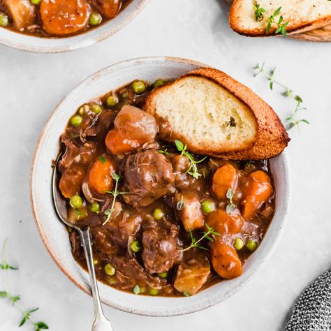 Mom's best ever slow cooker beef stew cooked to perfection with dry red wine, garlic, fresh herbs and tender potatoes and carrots. This easy beef stew recipe is just like the classic one you grew up with and makes a delicious, protein-packed dinner the whole family will love! #beefstew #slowcooker #slowcookerrecipe Dutch Oven Beef Stew, Oven Beef Stew, Dutch Oven Beef, Traditional Beef Stew, Slow Cooker Recipes Beef Stew, Easy Beef Stew Recipe, Easy Beef Stew, Hearty Beef Stew, Ambitious Kitchen