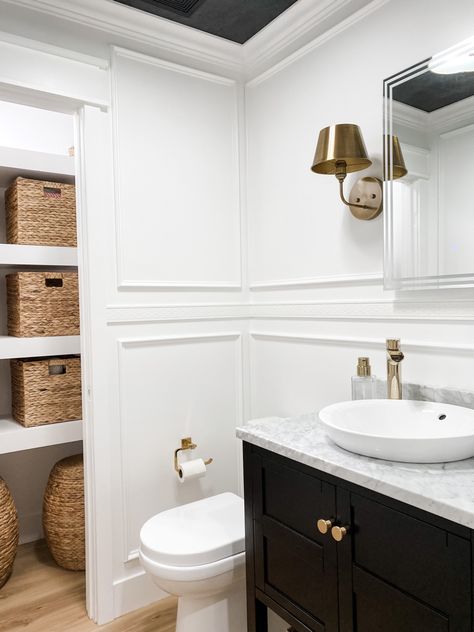 White box trim walls, a black vanity with marble counter, semi recessed vessel sink and brass fixtures Powder Room Box Trim, Box Trim Bathroom, Black And White Powder Room, White Powder Room, Box Trim, White Vessel Sink, Mirror Sconces, Semi Recessed Sink, Powder Room Makeover