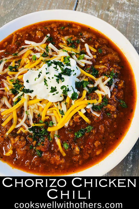 chili in a bowl with cheese and sour cream Chili Quiles Recipes, Ground Chicken Chilli Recipes, Chorizo Chili Recipe Crock Pot, Chicken Chorizo Chili, Ground Chicken Chorizo Recipe, Red Chili Chicken, Beef Chorizo Chili, Chili With Chorizo, Chicken And Chorizo Stew Slow Cooker