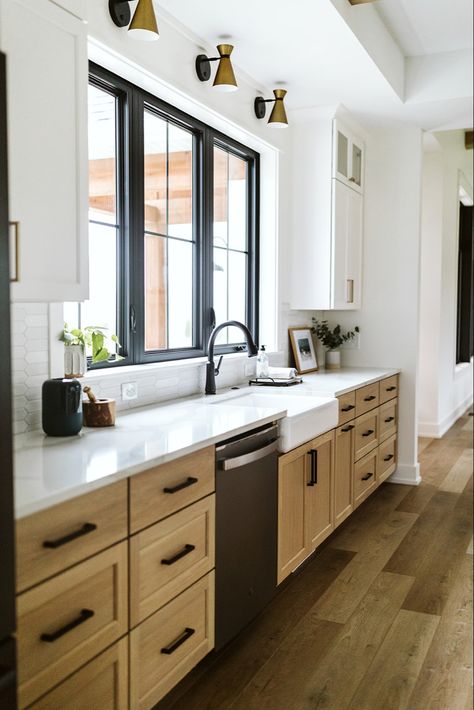 Black Countertops Wood Cabinets Modern, White Cabinets Black Windows, Modern Natural Wood Kitchen, Black Kitchen Window Over Sink, White Countertops Wood Cabinets, Kitchen Cabinets Around Window, Wood Upper Cabinets Painted Lower, Wood Cabinets Black Countertops, Oak Cabinets With Black Hardware