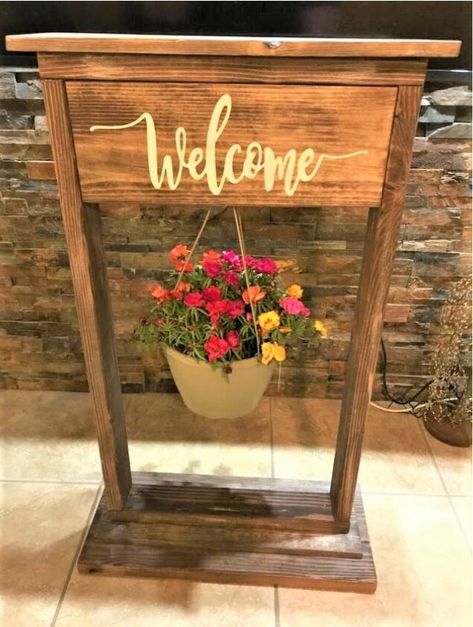 I have seen many planters like this, and I wanted to try making one myself. This is a great addition for your summer porch! Here's how I made it.Here is my cut list:2x4” 2@ 36” sides2x4 2@ 22” top and bottom frame2x10” 1@ 26” very bottom1x8 2@ 24” bottom and finishing top1x8” 19.5” cut lastFirst cut all of the boards you'll need. Once cut, sand all of them down.Next, lightly dry brush some white paint on all sides of the boards.Next, paint some wood stain over the paint- this will… Plant Stand Plans, Welcome Stand, Hanging Basket Stand, Planter Hanger, Woodworking Gifts, Garden Spheres, Diy Concrete Planters, Wood Planter, Wood Planter Box