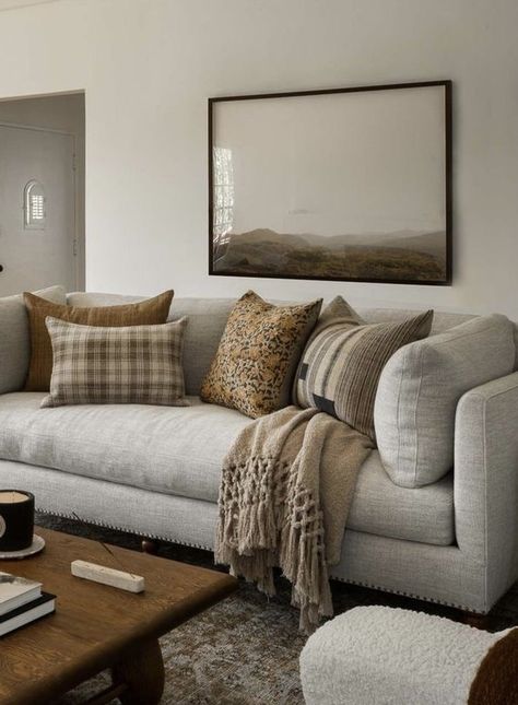 Grey Couch Beige Carpet, How To Decorate With Grey Walls, Winter Cosy Home, Heather Grey Couch Living Room, Modern Colonial Living Room Ideas, Lounge Room Styling Grey Couch, Gray Couch With Brown Accents, White And Dark Brown Living Room, Greige Couch Living Room