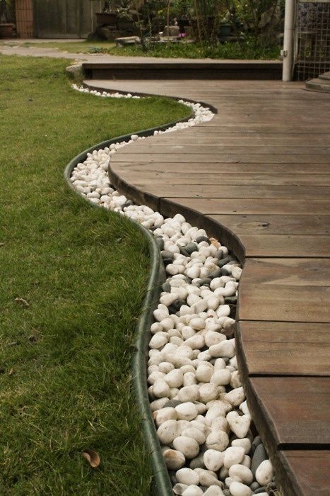 Use rocks to separate the grass from the deck, then bury rope lights in the rocks for lighting. Awesome idea Wooden Deck, Rope Lights, Garden Edging, Beautiful Backyards, Budget Backyard, Camping Ideas, The Deck, Deck Decorating, Ideas For