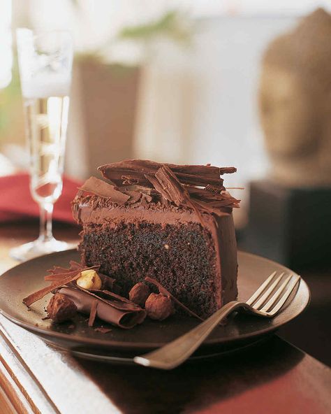 This luscious chocolate-hazelnut cake is coated with a ganache made from chocolate and cream. It's topped with a mountain of bittersweet chocolate curls, and surrounded by crunchy praline hazelnuts coated in tempered chocolate and rolled in cocoa powder. Belgian Chocolate Cake, Chocolate Hazelnut Cake, Chocolate Raspberry Cake, Hazelnut Cake, Chocolate Cream Cheese, Raspberry Cake, Birthday Cake Chocolate, Belgian Chocolate, Round Cake Pans