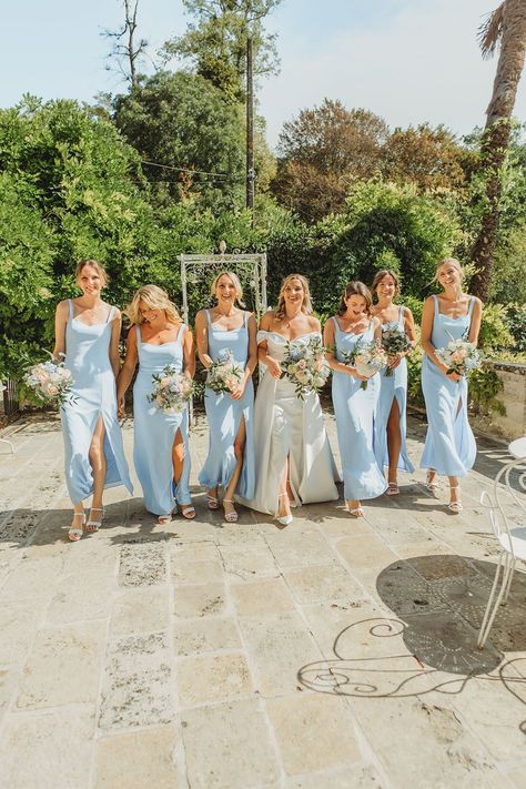 Bridesmaids wearing powder blue bridesmaid dresses with the bride in an off the shoulder wedding dress Powdered Blue Bridesmaid Dress, Dusty Blue Wedding Theme Bridesmaid, Bridesmaid Dresses French Blue, Revelry Blue Bridesmaid Dresses, Summer Blue Bridesmaid Dresses, Bridesmaid Dresses Pale Blue, Bridesmaid Colors Blues, Bridesmaids Light Blue, Cornflower Blue Bridesmaids