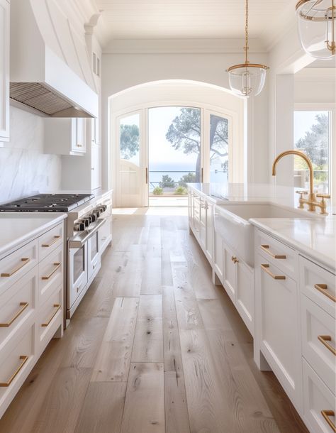 White Washed Wood Floors Kitchen, Cream And Gold Kitchen Cabinets, New White Kitchen, White Dream Kitchen Inspiration, Light Wood Floors White Cabinets, White Kitchen With Silver Appliances, White And Gold Cabinets Kitchen, Range Hood With White Cabinets, Kitchens With Gold Accents