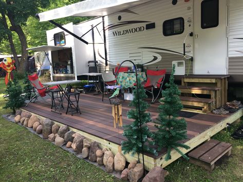 Camper Living Outdoor Decor, Permanent Camper Site Ideas Camping, Rv Spots Ideas, Camper Porch Decorating, How To Hide A Dumpster, Camper Outdoor Set Up Decor, Travel Trailer Permanent Site Ideas, Outdoor Camper Patio Ideas, Permanent Campsite Ideas Diy