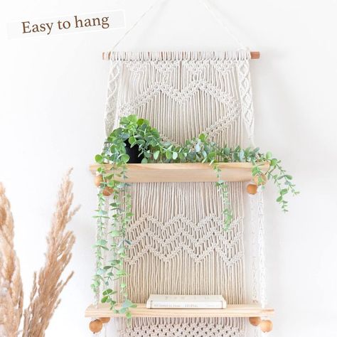 BE BOHO FREE and embrace the laid back, casual chic lifestyle of modern rustic living. macrame wall hanging shelf can elevate any room its hung in .EASY TO HANG indoors or out. Perfect decor piece for the home or apartment. Use our boho shelves in the bedroom, bathroom or dining room, or as wall hanging shelves for plants on the porch . our macrame shelf makes it easy to decorate any space. Beautiful hanging wall shelves for collectibles and photos, books in a dorm, office or a plant wall . Boho Shelves, Macrame Wall Hanging Shelf, Macrame Hanging Shelf, Wall Shelf Display, Botanical Display, Wall Hanging Shelf, Indoor Plant Wall, Macrame Shelf, Wall Plant Hanger