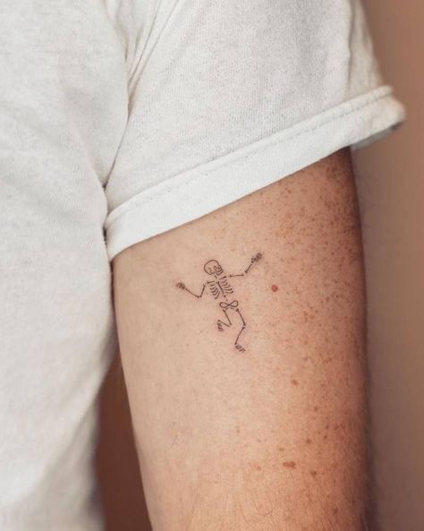 Fine line style dancing skeleton tattoo located on the Fall Related Tattoos, Dancing Skeleton Tattoo Simple, Skeleton Flash Tattoo, Halloween Fine Line Tattoo, Fine Line Skeleton Tattoo, Minimalist Halloween Tattoo, Cute Halloween Tattoos Ideas, Fine Line Halloween Tattoo, Tiny Skeleton Tattoo