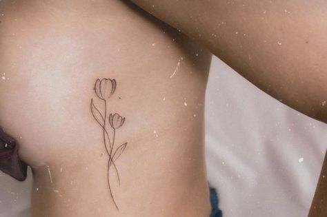 Tulip Side Tattoo, Tulip Tattoo Side Rib, Tulip Spine Tattoos For Women, Wrist Tattoos Words, Thumb Tattoos, Minimal Tattoo Ideas, Tulip Tattoo, Ribcage Tattoo, Henna Stencils