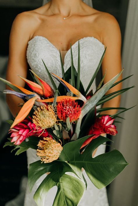 Florida Bride in Lace and Illusion Strapless Wedding Dress Holding Tropical Floral Bouquet, Yellow and Red Pincushion Proteas, Pink Ginger, Birds of Paradise, Monstera Palm Tree Leaves | Tampa Bay Wedding Photographer Amber McWhorter Photography Hawaiian Floral Bouquet, Unique Tropical Wedding Ideas, Cascading Tropical Bouquet, Birds Of Paradise Bridal Bouquet, Green Tropical Bouquet, Olive Green Tropical Wedding, Red Tropical Bouquet, Tropical Flowers For Wedding, Wedding Tropical Bouquet