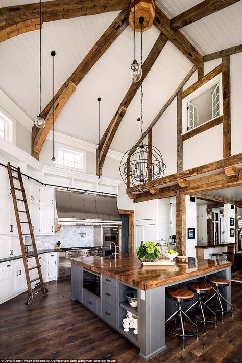 Stunning: This American property was singled out for its large kitchen island work space and quirky ladders used to reach extra storage. This Midwest Lake House renovation was completed in 2015 and cost more than $2,000,000 (£1.58million). The owner has a lifelong passion for rowing and tasked the architects with designing a lake residence that would be reflective of classic American boathouse style Large Kitchen Island, Cottage Kitchens, Interior Design Magazine, The Ceiling, Farmhouse Style House, Large Kitchen, Style At Home, House Goals, Beautiful Kitchens