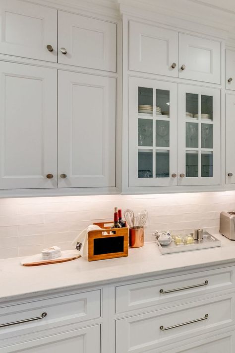 Custom kitchen renovation in Tuscaloosa, AL, featuring white cabinets with drawers and doors, a glass display cabinet, white countertop, and white zellige subway tile backsplash. Classic Timeless Kitchen Design, Classic Timeless Kitchen, Shaker Cabinets Kitchen, Lowes Kitchen Cabinets, Classic Kitchen Cabinets, Cabinet Classic, Timeless Kitchen Design, Timeless Kitchen, Shaker Cabinets