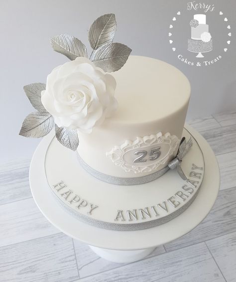 25th (silver) wedding anniversary cake with white sugar rose and siliver leaves Silver Wedding Anniversary Cake Simple, Silver Anniversary Cake Ideas, 25th Wedding Anniversary Cake Design, Silver Wedding Cake Ideas, 25th Anniversary Cake Ideas Unique, 25 Wedding Anniversary Cakes, 25 Th Anniversary Cake, 60th Wedding Anniversary Cakes, White And Silver Cake