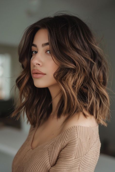 Woman with wavy brown hair in a beige sweater looking over her shoulder. Long Bob Brunette Balayage, Balayage Brunette Short Hair, Brown And Copper Highlights, Balayage Bob Brunette Caramel, Short Hair Caramel Highlights, Caramel Balayage Brunette Short Hair, Honey Brown Balayage Short Hair, Light Brown Balayage Short Hair, Brunette Balayage Hair Caramel