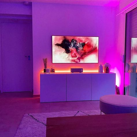 TV and entertainment center illuminated by orange, pink, and purple Philips Hue smart lighting. Ambient Lighting Living Room Night, Hue Light, Led Entertainment Center, Led Lights Home Decor, Led Light Home, Hue Lights Bedroom, Living Room Lighting Night, Light Bar Living Room, Hue Lightstrip Ideas