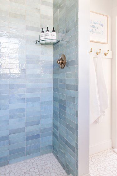 Blue Shower Tile Ideas and Inspiration | Hunker Seafoam Green Tile Bathroom, Bath Shower Combo Tile Ideas, Scallop Shower Tile, Dave And Jenny Marrs Bathrooms, Bathroom Tile Schemes, Beachy Shower Tile Ideas, Blue Walk In Shower Ideas, Blue Porcelain Tile Bathroom, Blue Zellige Bathroom