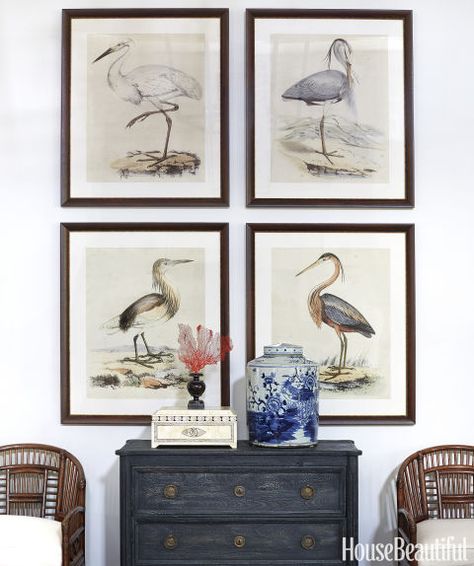 In the great room, the designer placed heron prints from Art.com over Anthropologie's Indigo Washed dresser. Click through for more blue and white home decor and gorgeous pictures of this Naples home. Summer Thornton, Art Placement, Nautical Painting, Chinoiserie Chic, Tropical House, Blue And White China, Picture Hanging, White Home Decor, Florida Home