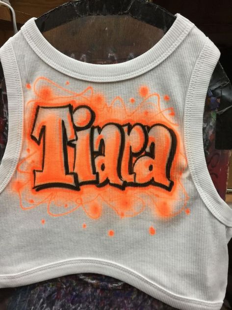 Airbrushed lettering by Air Graphics. 610-921-8300. email us at info@airgraphicsstore.com. we ship across USA and Canada. We airbrush lettering, names, logos, birthday events, In Loving Memory RIP, banners,sport teams, graduation shirts, hoodies, masks, you name it! Airbrush Tank Top, Airbrush Clothes Birthday, Airbrush Rip Shirts, Air Brush Shirts 90s, Airbrush Name Shirts, Graduation Shirts, Airbrush Art, Sports Team, Graphic Tshirt