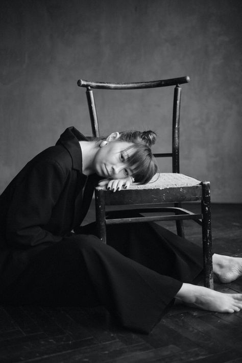 Barefoot Woman in Black Leaning Head on Chair · Free Stock Photo