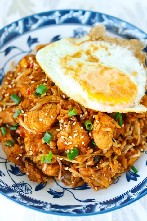 Kimchi Fried Rice with Chicken is easy to make in one wok and full of BIG and BOLD flavors! This Korean fried rice is made with savory tender chicken pieces, tangy kimchi, fragrant aromatics, veggies and the most delicious gochujang infused spicy, smoky, and tangy sauce with a hint of sweetness. Ready in 30 minutes, it’s the perfect tasty meal for busy weeknights! #kimchi #kimchifriedrice #highproteinmeals #koreanfood #korean #healthy #dinner #mealprep #maindish #friedrice | That Spicy Chick Chicken Kimchi Fried Rice, Korean Fried Rice, Asian Dinner, Rice With Chicken, Asian Dinners, Kimchi Fried Rice, Chicken Pieces, Chicken Fried Rice, Chicken Stir Fry