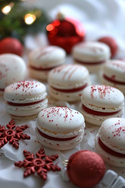 Festive white macarons with red filling, decorated with red sprinkles and surrounded by red ornaments and snowflakes. Christmas Confectionary Ideas, Fancy Christmas Baking, Macaron Christmas Gift, Macaroon Gift, Christmas Confections, Christmas Macarons Recipe, Macarons Christmas, Xmas Macarons, Christmas Macarons Flavors