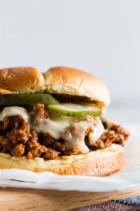 These sloppy Cubanos are the perfect spin to the traditional Sloppy Joe. A delicious mixture of ground pork, chorizo, spices, lime, and tomato piled high on a bun and topped with Swiss cheese and pickles. It's the perfect mashup of a Cuban sandwich and Sloppy Joe. Sandwich Cubano, Pork Chorizo, On A Bun, Sloppy Joes Recipe, Pork Sandwich, Sloppy Joe, Sloppy Joes, Swiss Cheese, Family Favorite Meals