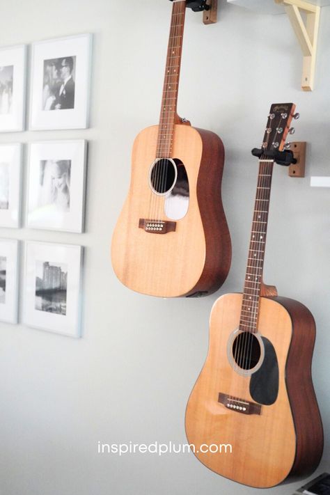 Check out our living room acoustic guitar display for tips to hang your instruments and decorate your space. Click to see how we've decorated our home with multiple guitars, mandolins, and a piano! Acoustic Guitar Display, Living Room Music Decor, Ukulele On Wall Decor, Guitar In Bedroom Aesthetic, Violin Wall Mount, How To Hang Guitars On The Wall, Guitar Mounted On Wall, Display Guitars On Wall, Guitar Wall Mount Ideas