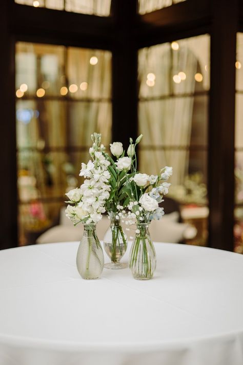 Classic Floral Centerpieces, Cocktail Table Bud Vase Wedding, Dusty Blue Bud Vases Wedding, White Floral Table Arrangements Wedding, Little Vases Wedding Table, Bud Vases Wedding Cocktail Table, All White Bud Vases Wedding, Cocktail Tables Centerpieces, White And Green Wedding Table Flowers