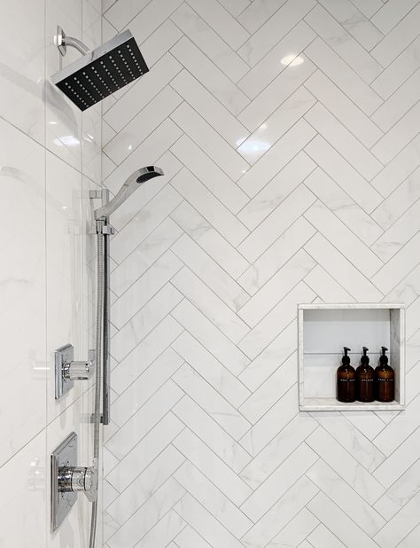 Custom shower ideas. Marble look porcelain herringbone accent shower wall with shower niche and Delta Faucet shower fixtures. White Herringbone Shower Tile, Shower Faucet Ideas, Herringbone Bathroom Wall, Herringbone Bathroom Tile, Herringbone Shower Wall, Style A Bathroom, Herringbone Shower Tile, Church Bathroom, Herringbone Shower