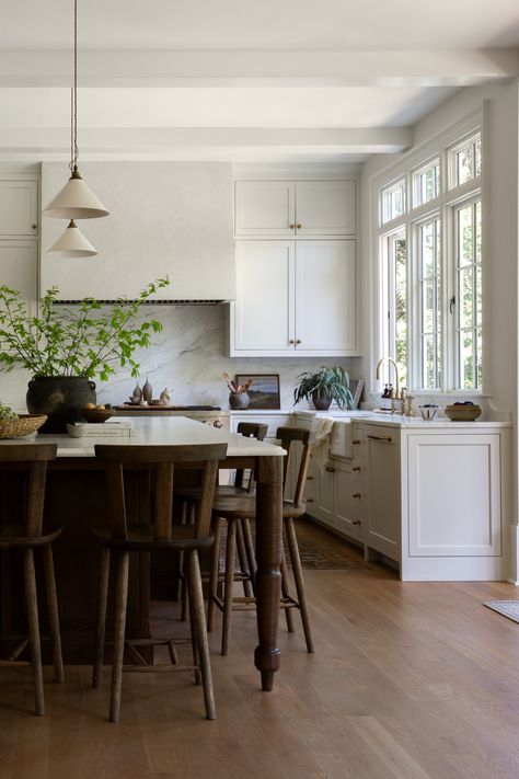 Light filled European inspired kitchen renovation with large kitchen island and pendant lighting in Roswell, Georgia by Prescott Design Dining Table As Island In Kitchen, Table As Island In Kitchen, Light And Dwell Kitchen, Large Kitchen Island Styling, Large Island Decor, Transitional House Decor, Large Kitchen Island Decor, Two Pendant Lights Over Kitchen Island, Dark Brown Island